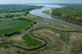 An aerial photo of the Great Bay Estuary in the distance and one of its tributaries in the foreground.